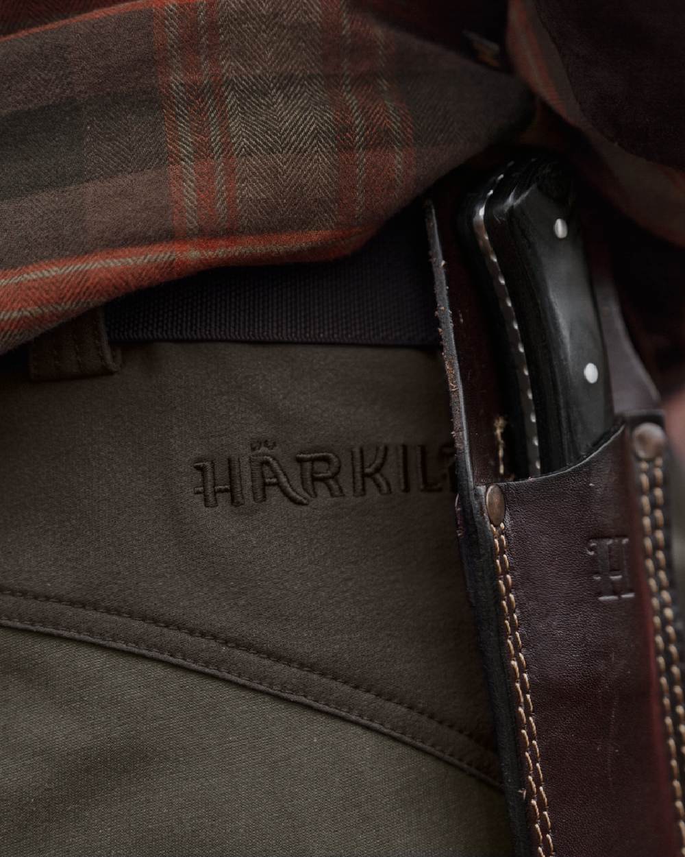 Black Olive Forest Night coloured Harkila Hill Trousers on outdoor background