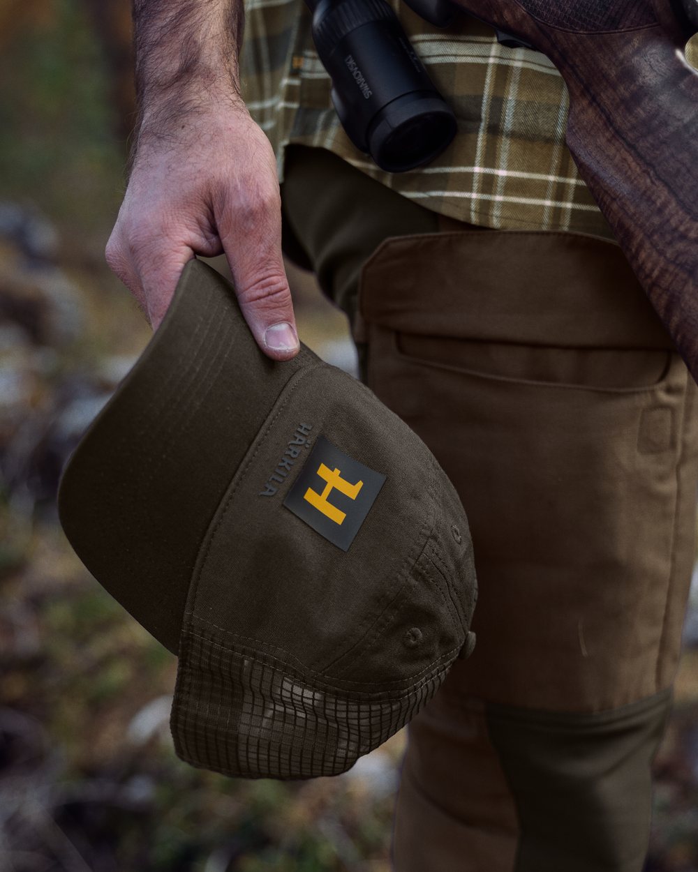 Willow Green Coloured Harkila Instinct Cap on blurry background