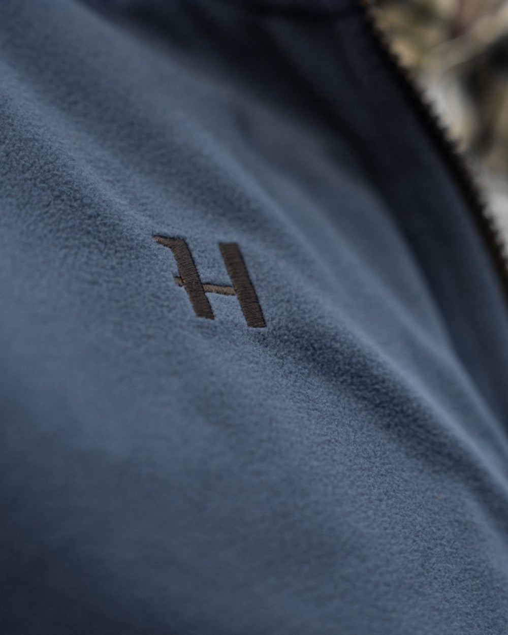 Dark Olive Sea Blue Coloured Harkila Kamko Estate WSP Reversible Waistcoat on outdoor background