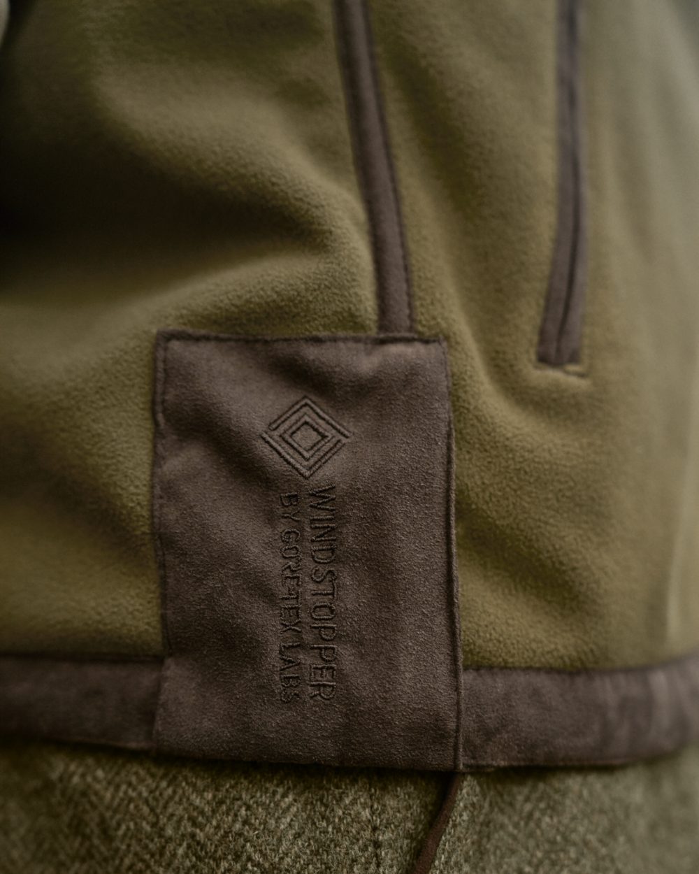 Dark Olive Sea Blue Coloured Harkila Kamko Estate WSP Reversible Waistcoat on outdoor background