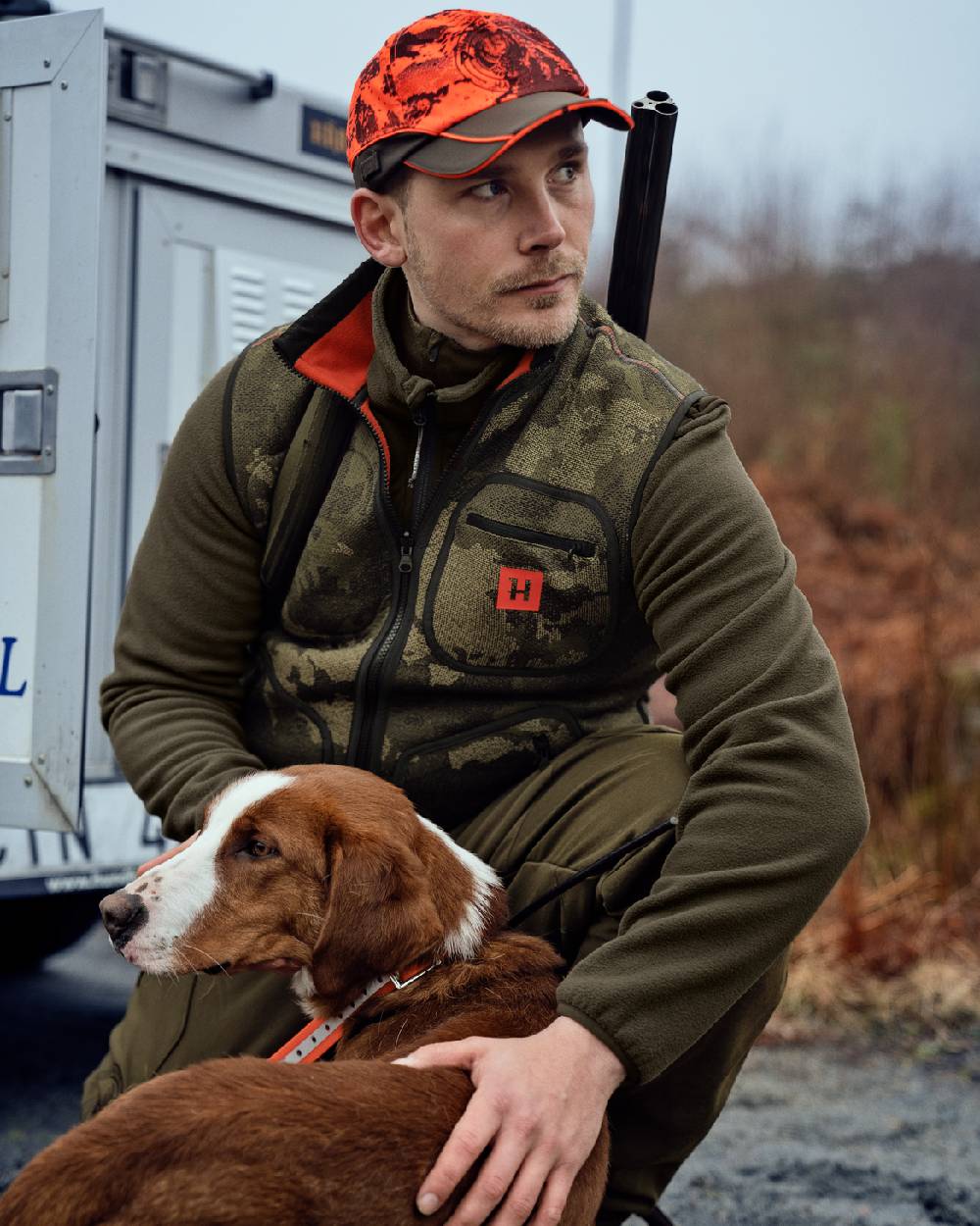 AXIS Limited Edition Orange Coloured Harkila Kamko Pro Edition Reversible Hi-Vis Waistcoat on forest background