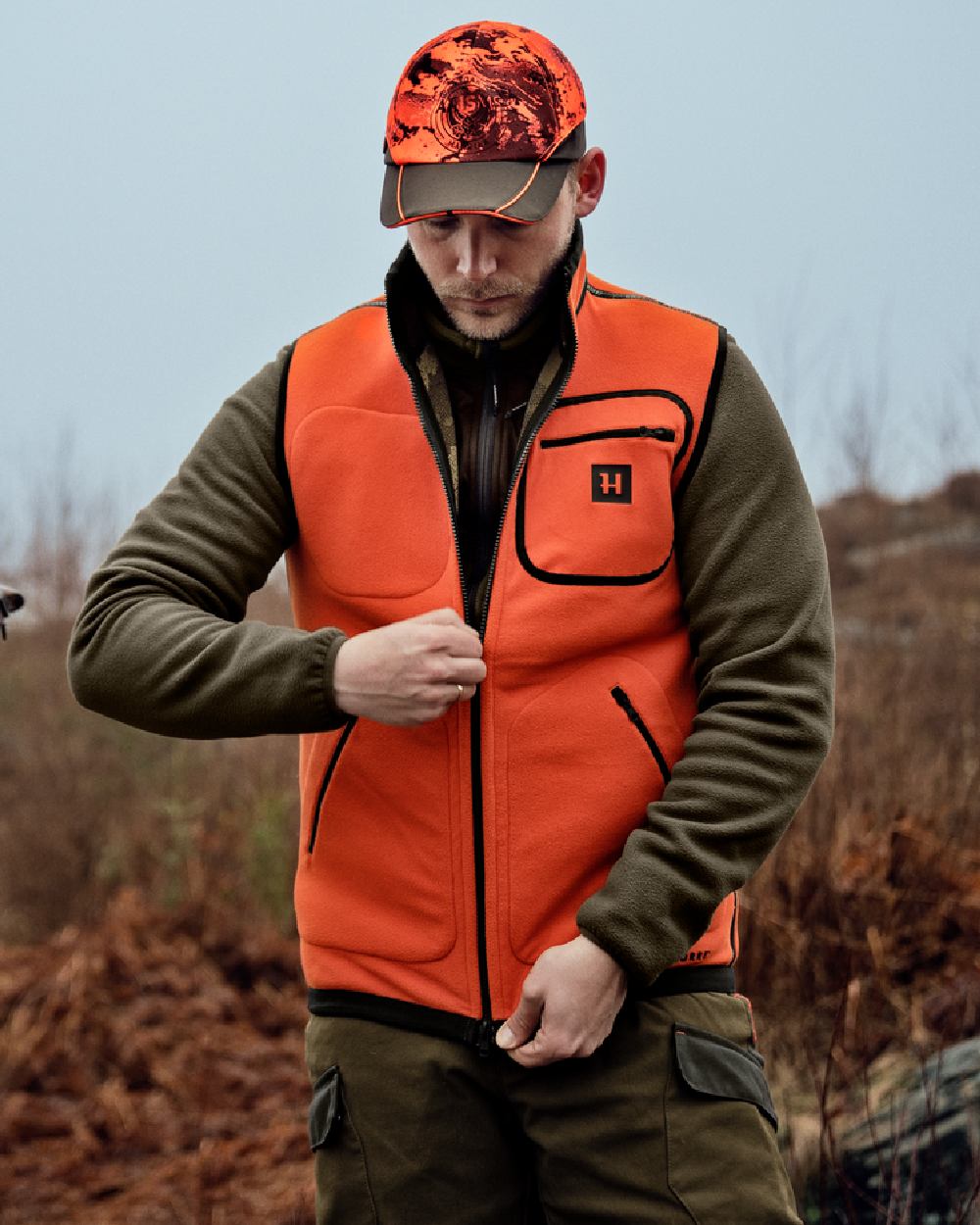 AXIS Limited Edition Orange Coloured Harkila Kamko Pro Edition Reversible Hi-Vis Waistcoat on forest background