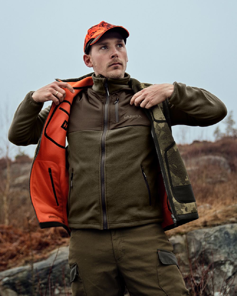 AXIS Limited Edition Orange Coloured Harkila Kamko Pro Edition Reversible Hi-Vis Waistcoat on forest background