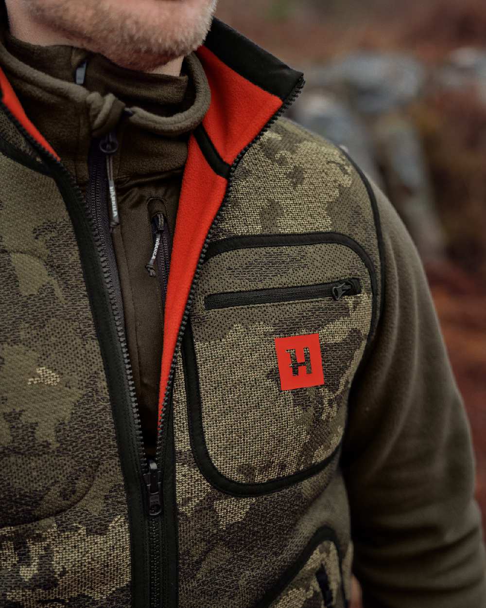 AXIS Limited Edition Orange Coloured Harkila Kamko Pro Edition Reversible Hi-Vis Waistcoat on forest background