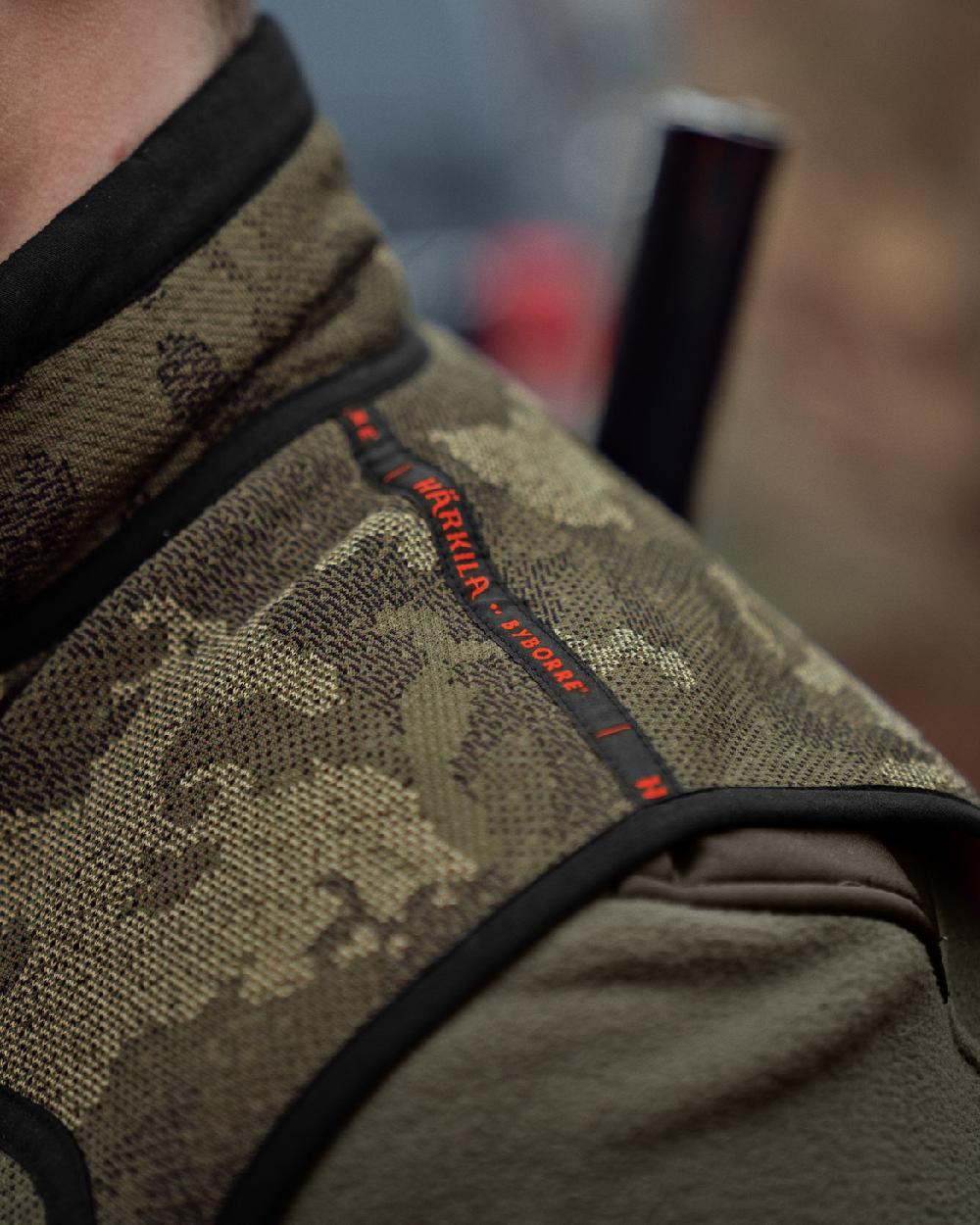 AXIS Limited Edition Orange Coloured Harkila Kamko Pro Edition Reversible Hi-Vis Waistcoat on forest background