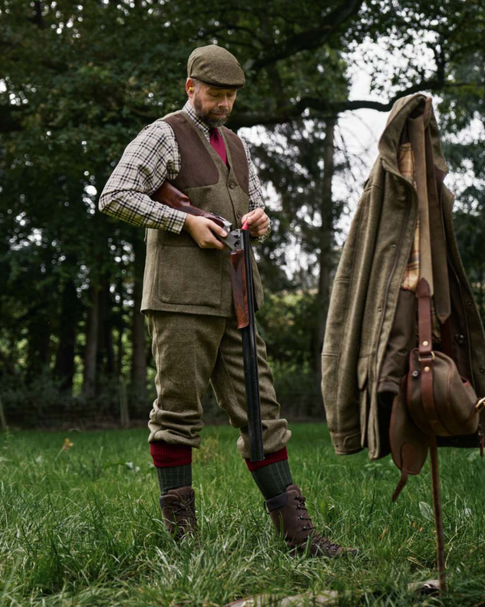 Forest Green Herringbone coloured Harkila Kenmore Shooting Waistcoat on forest background