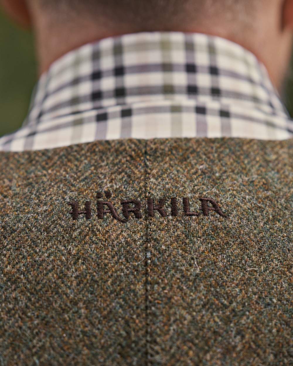 Forest Green Herringbone coloured Harkila Kenmore Shooting Waistcoat on forest background
