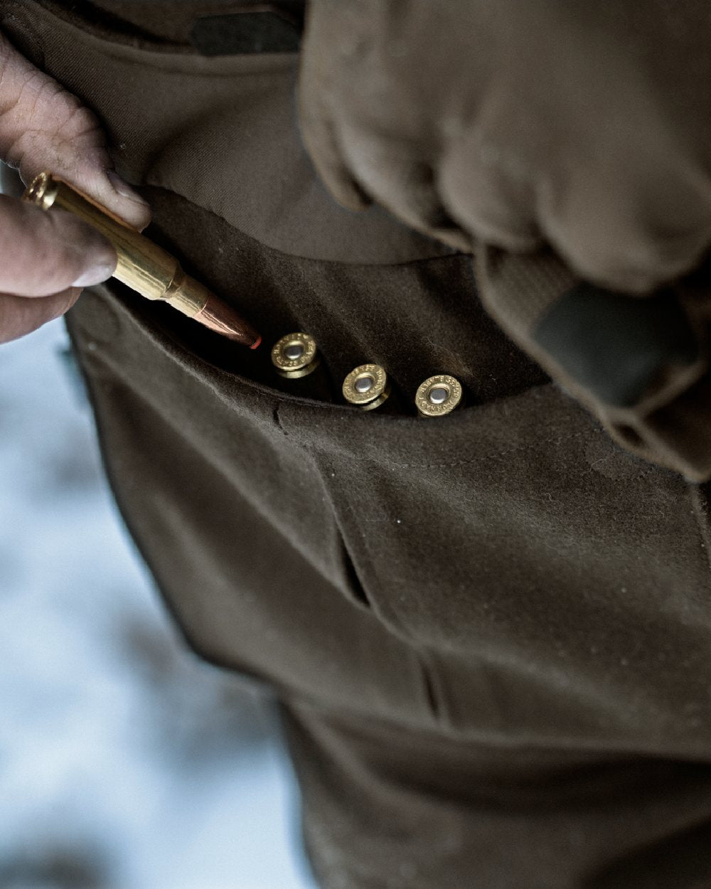 Dark Hunting Green Shadow Brown coloured Harkila Kodiak CleverWool HSP Insulated Jacket on snowy background
