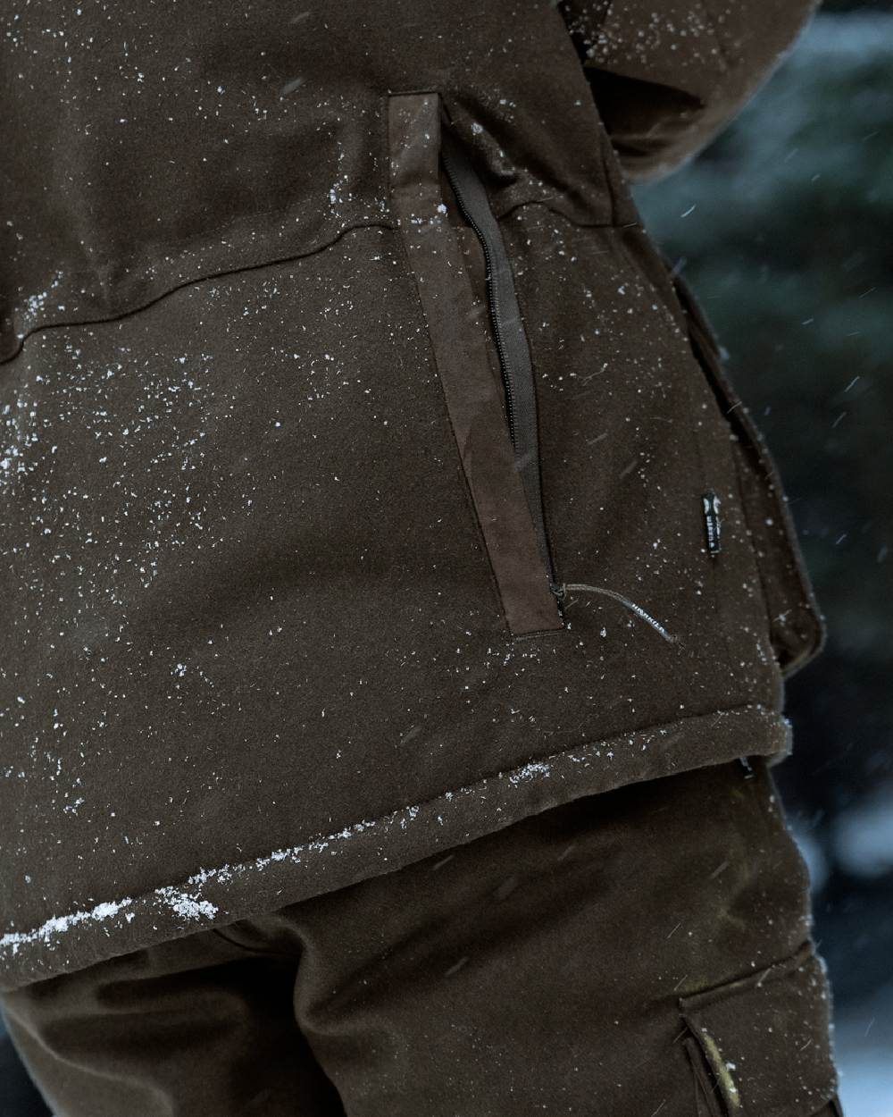 Dark Hunting Green Shadow Brown coloured Harkila Kodiak CleverWool HSP Insulated Jacket on snowy background