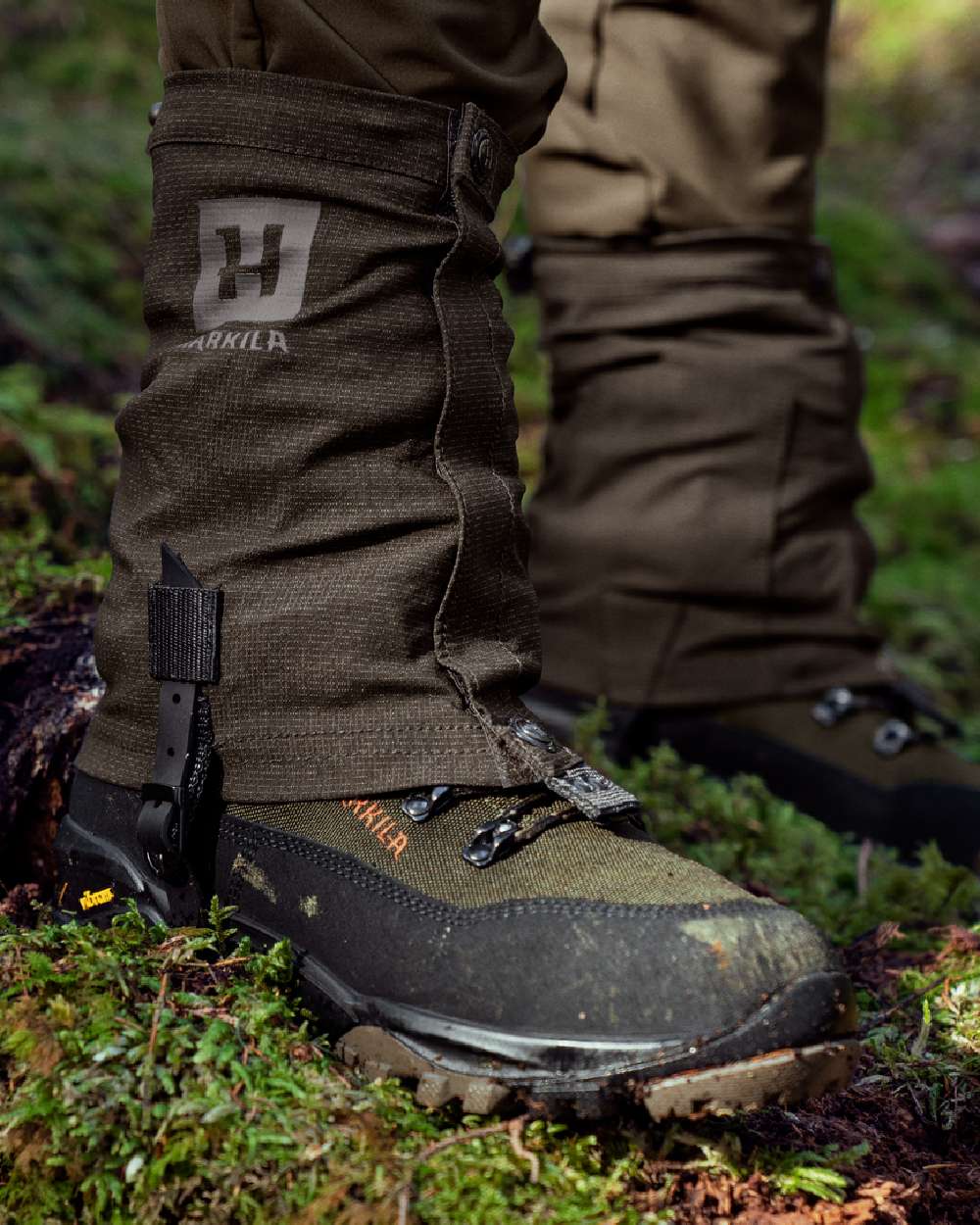 Shadow Brown Coloured Harkila Ledge Gaiters on forest background