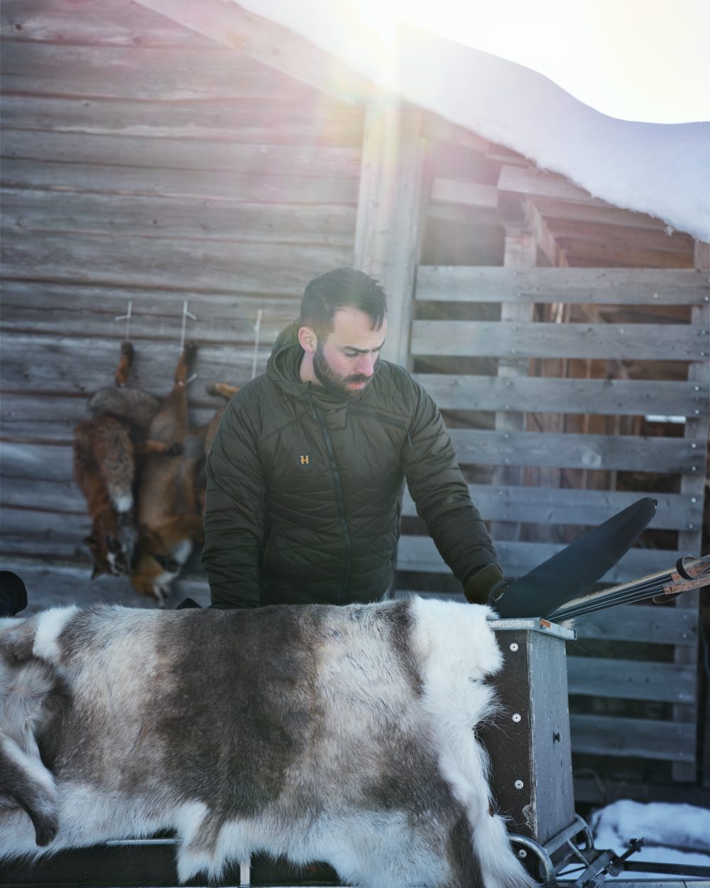 Willow Green Coloured Harkila Logmar Insulated Packable Hooded Jacket on snow background