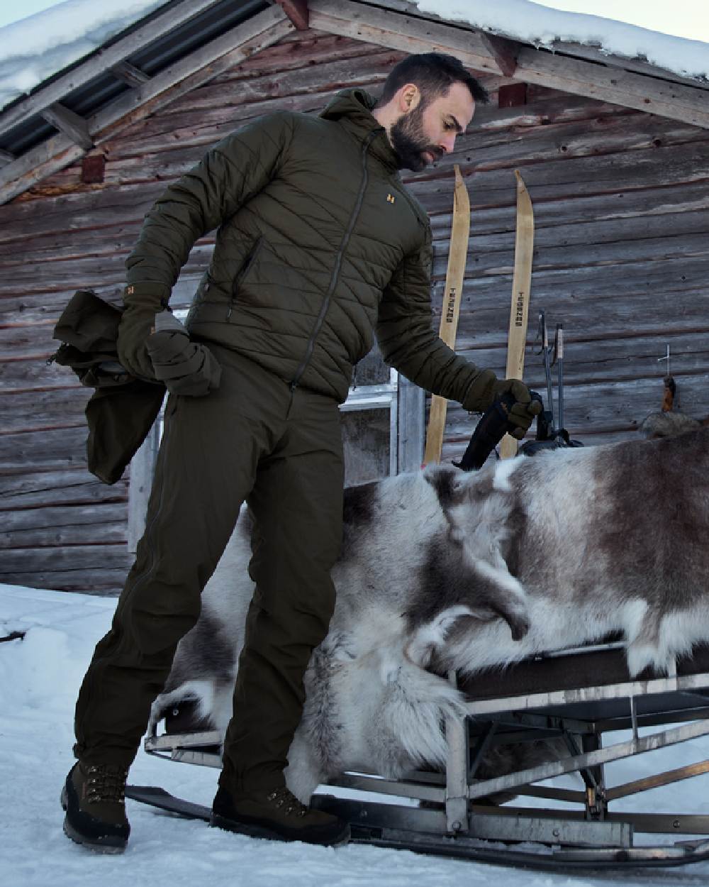 Willow Green Coloured Harkila Logmar Insulated Packable Hooded Jacket on snow background