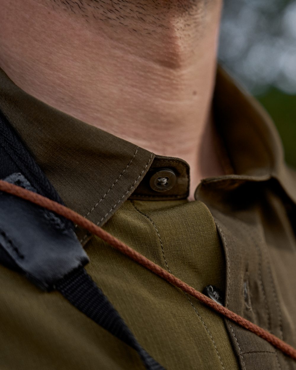 Dark Olive Willow Green Coloured Harkila Kenmore Cl. Flat Cap on forest background
