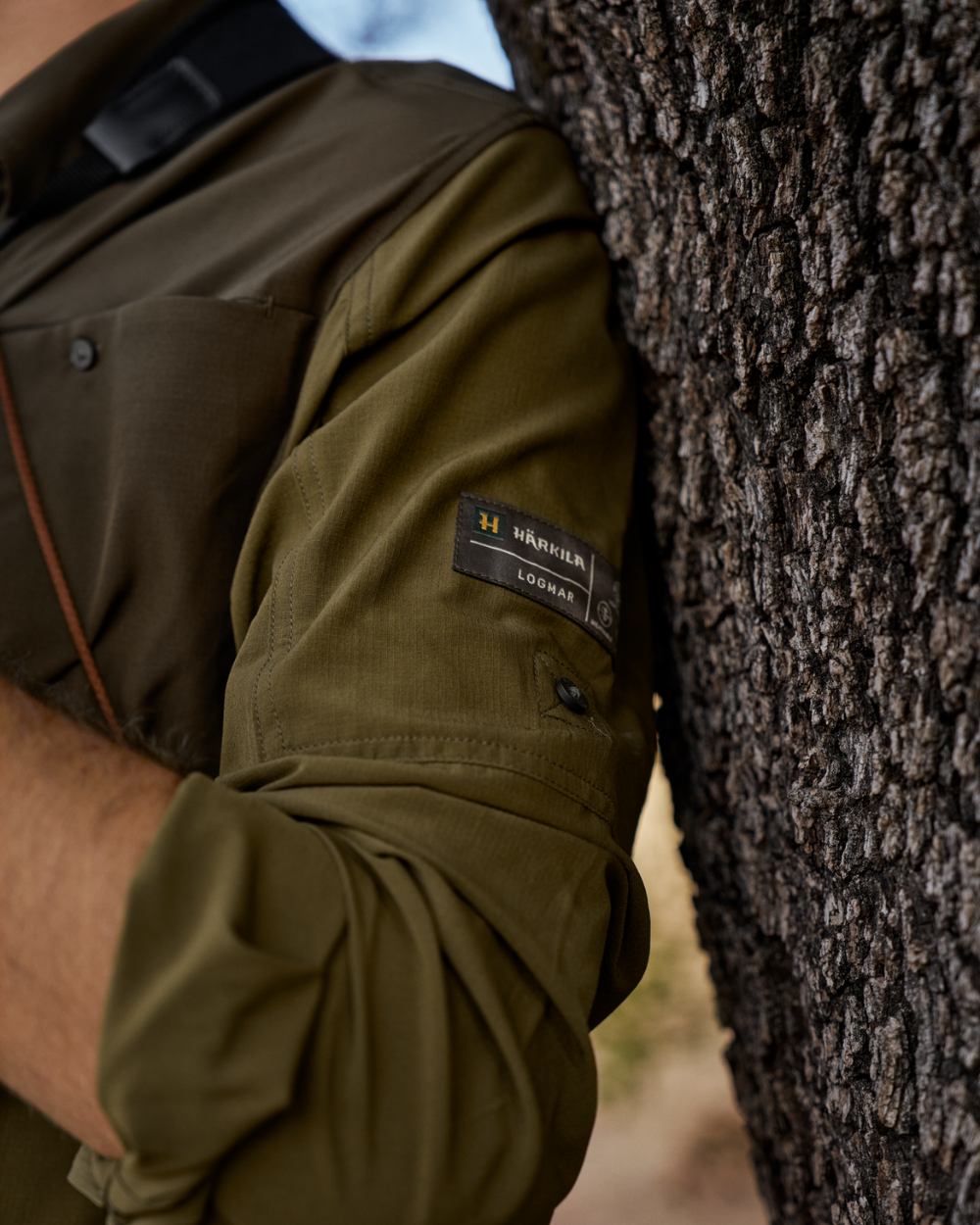 Dark Olive Willow Green Coloured Harkila Kenmore Cl. Flat Cap on forest background