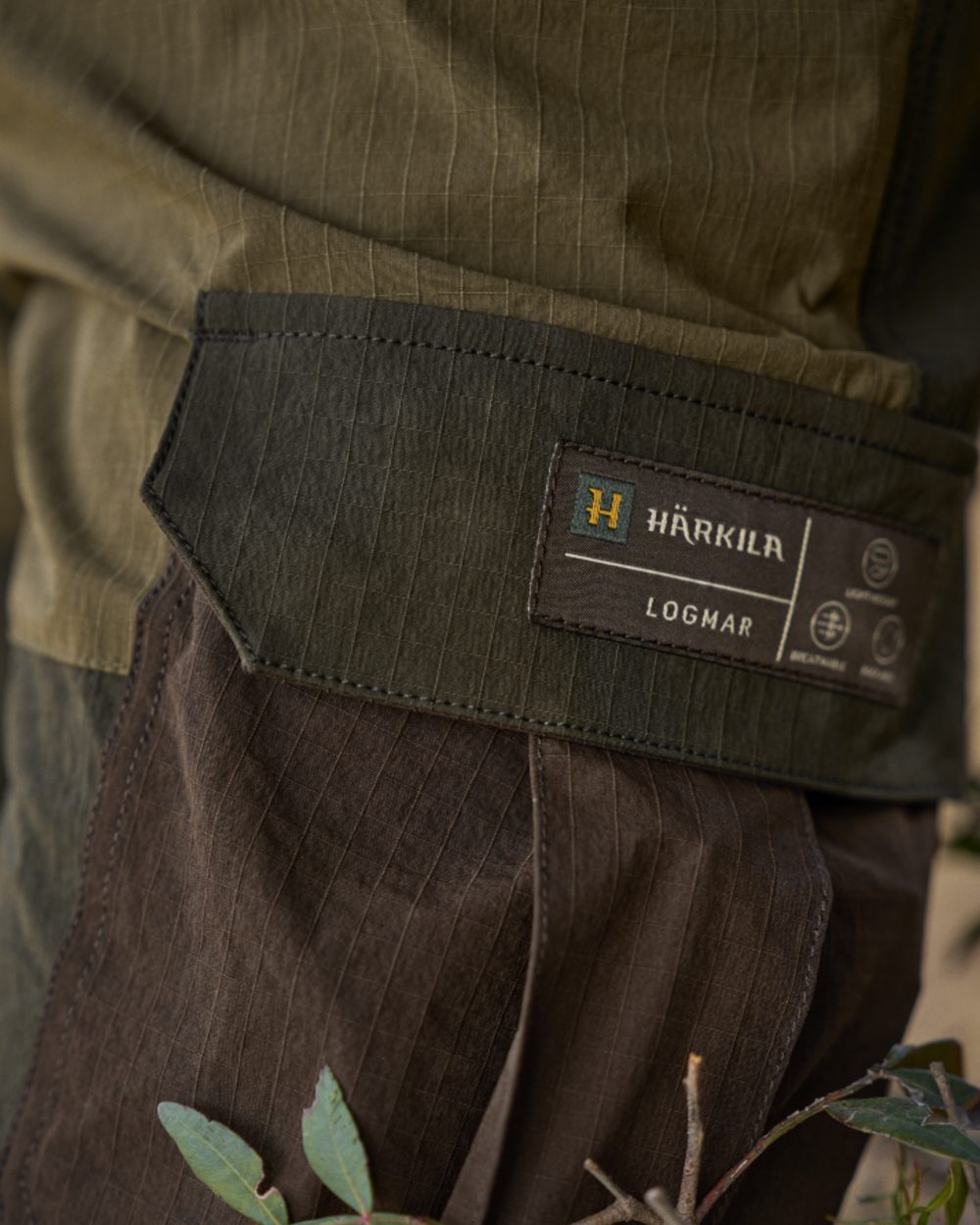 Dark Olive Willow Green Coloured Harkila Logmar Lightweight Zip Off Trousers on forest background