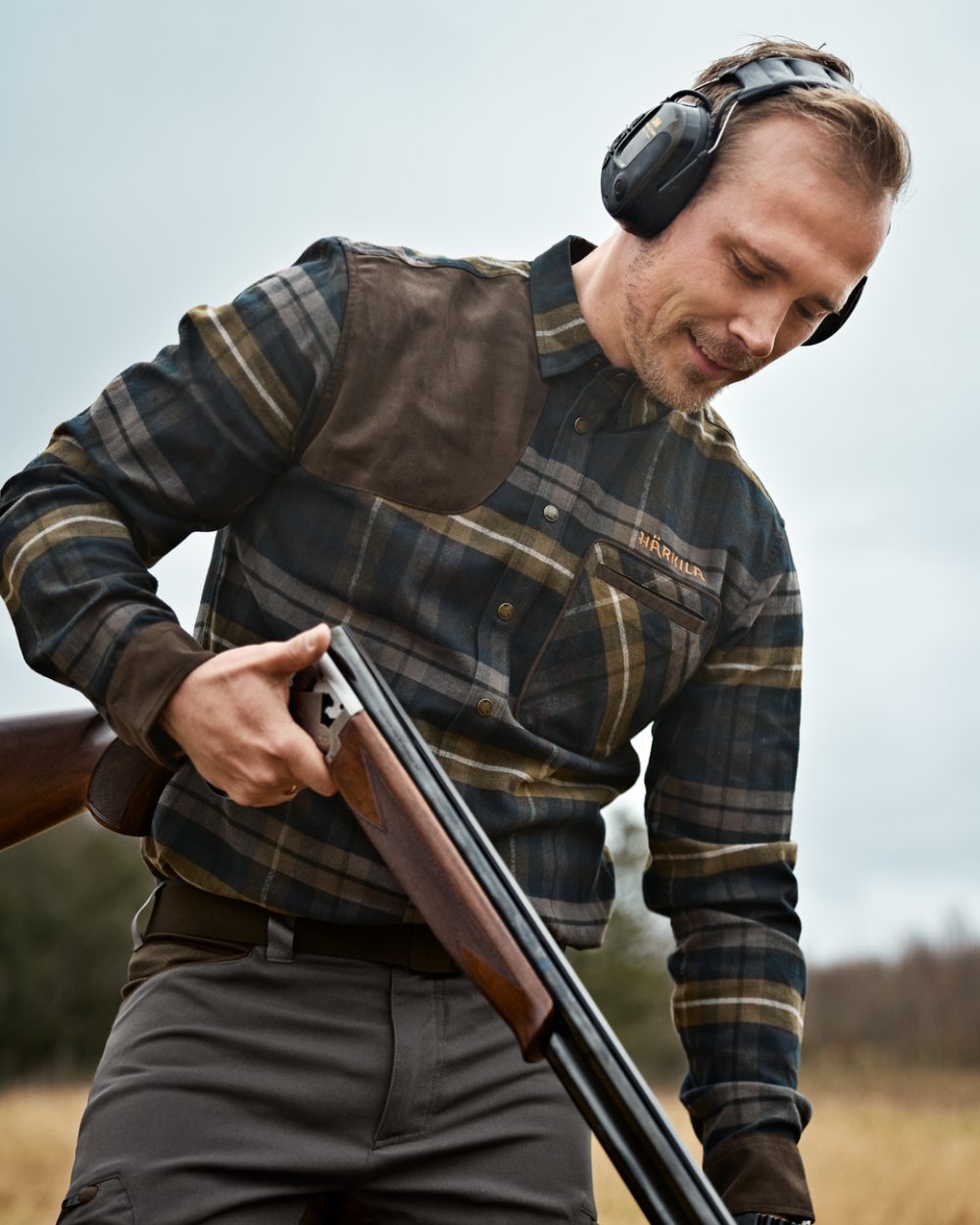 Dark Olive coloured Harkila Mens Jarne Shooting Shirt on forest background
