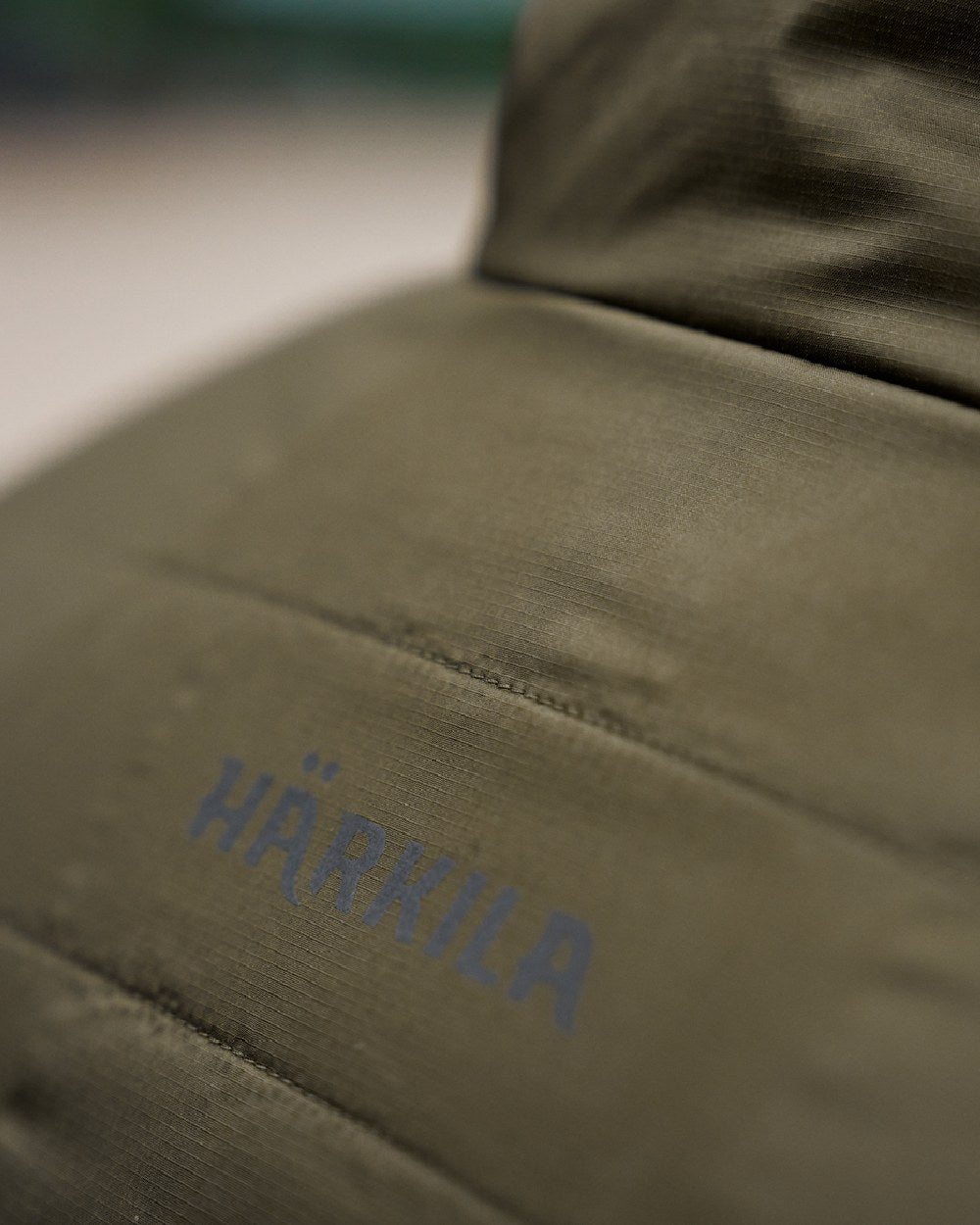 Willow Green Sea Blue Coloured Harkila Mens Kalix HSP Jacket on blurry background