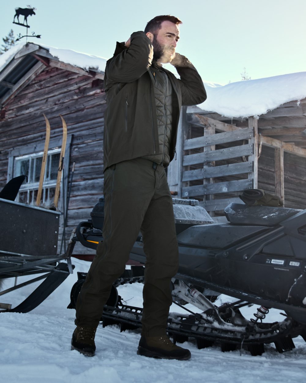 Willow Green coloured Harkila Mens Logmar HWS Packable Trousers on snow background