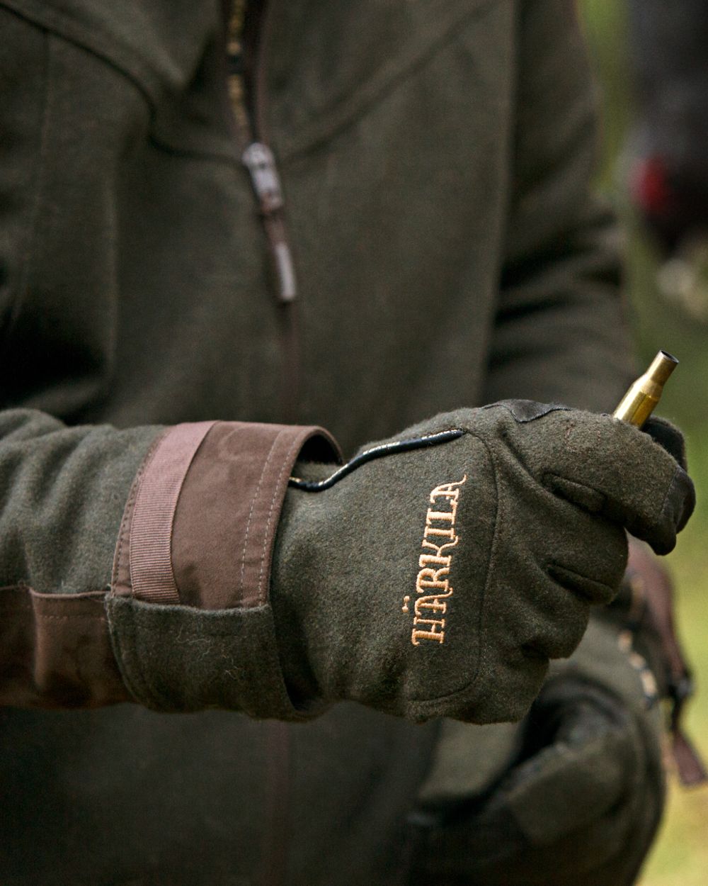 Willow Green Coloured Harkila Metso Active Gloves on blurry background