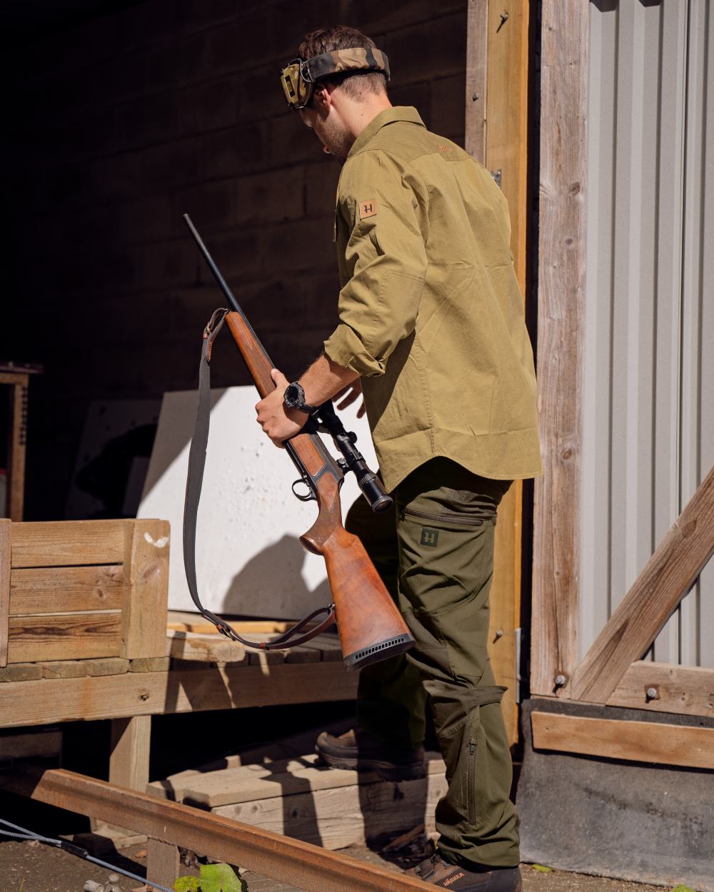 Hunting Green Shadow Brown Coloured Harkila Mountain Hunter Trousers on outdoor background