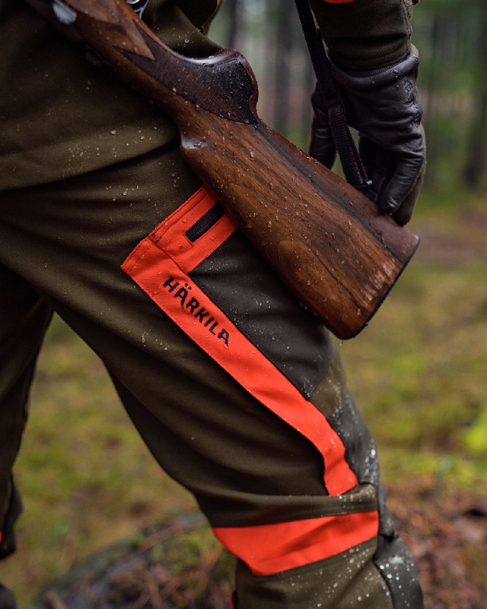 Willow Green Orange Coloured Harkila Pro Hunter Dog Keeper GTX Trousers on forest background