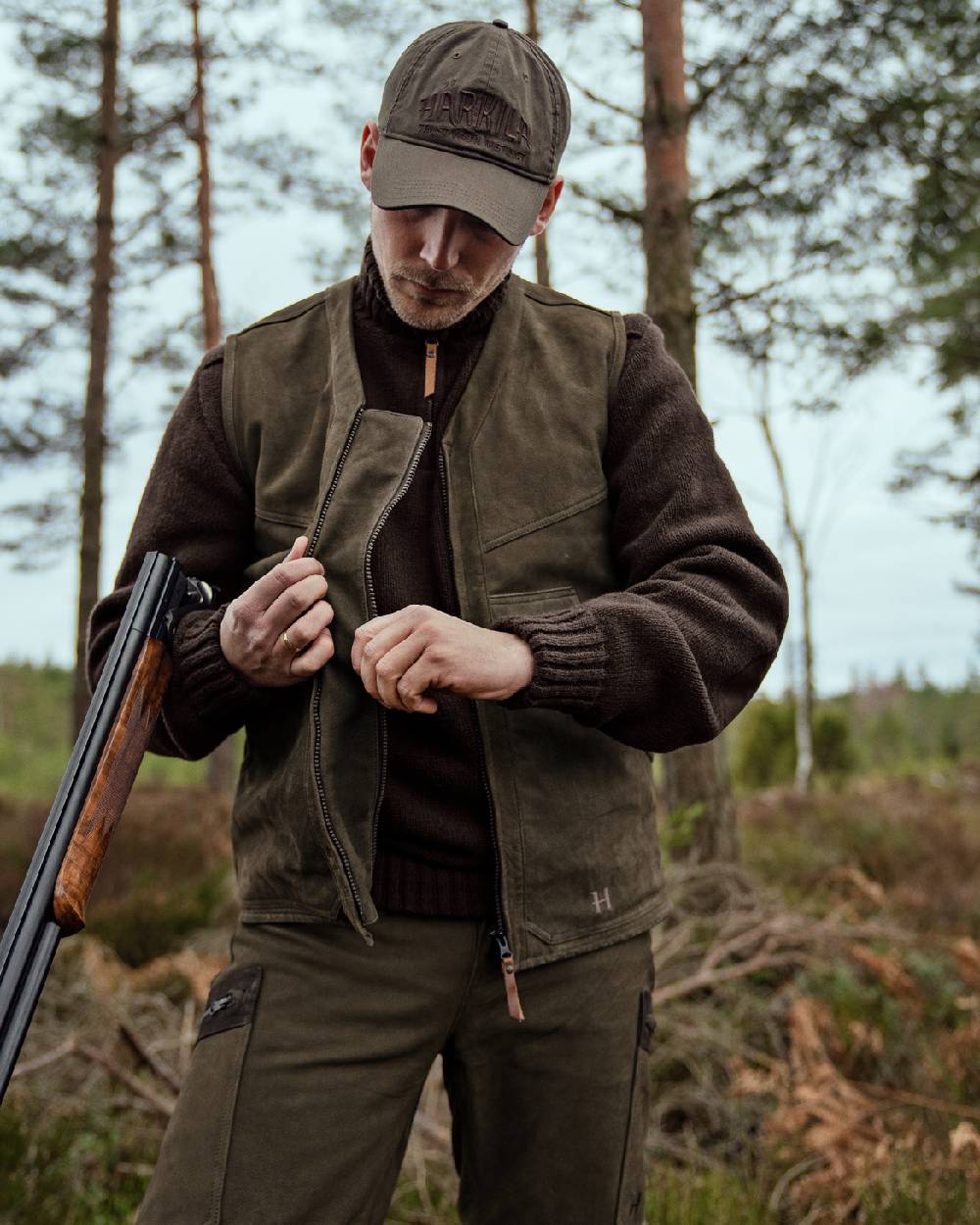 Willow Green Coloured Harkila Pro Hunter Leather Waistcoat on forest background
