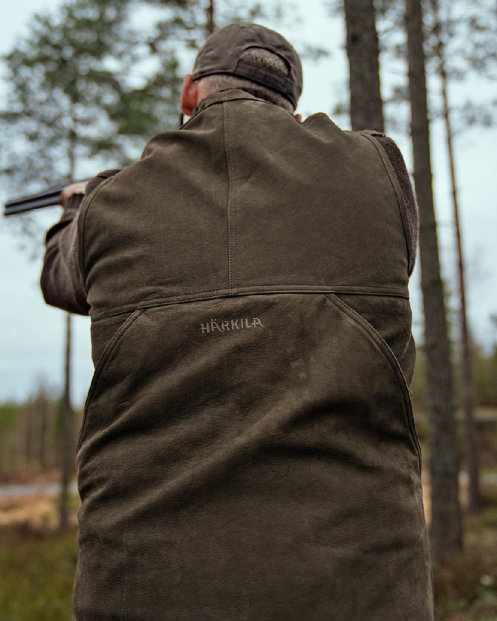 Willow Green Coloured Harkila Pro Hunter Leather Waistcoat on forest background