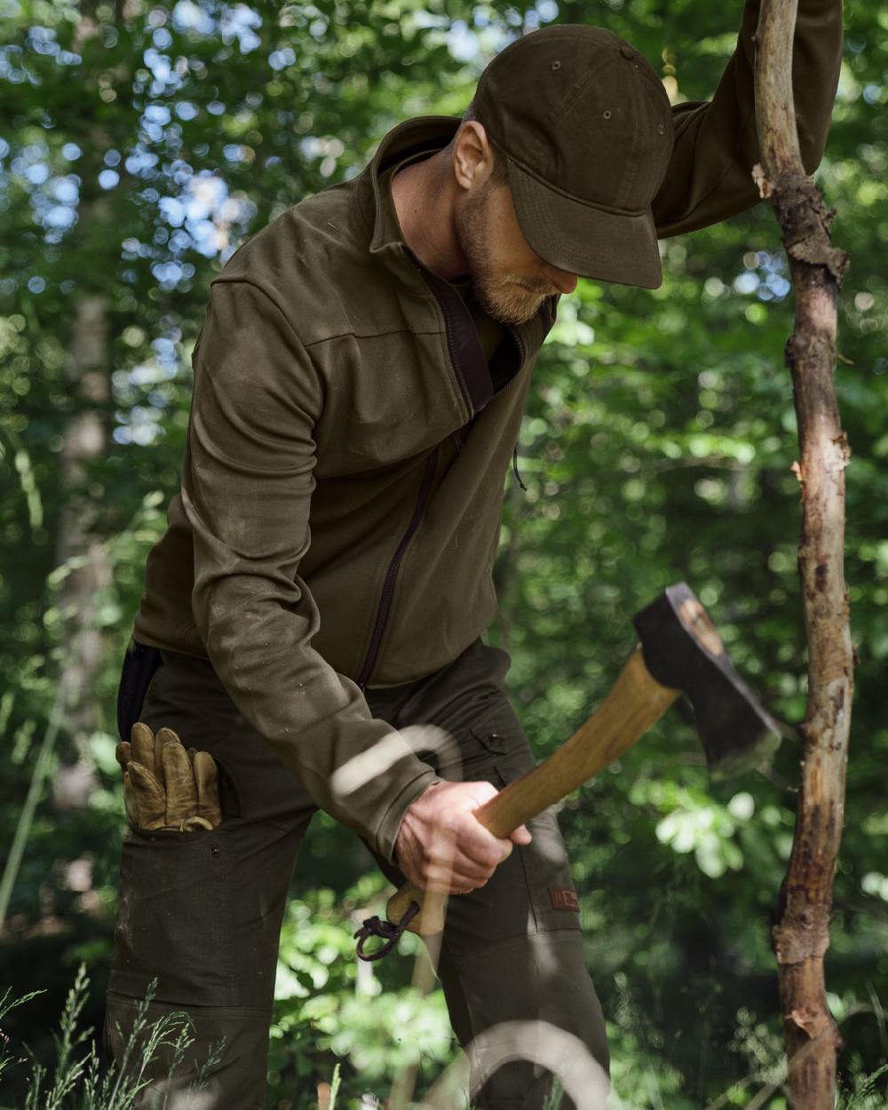 Light Willow Green Coloured Harkila Pro Hunter Light Trousers on forest background