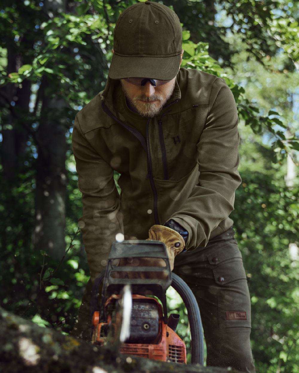 Light Willow Green Coloured Harkila Pro Hunter Light Trousers on forest background