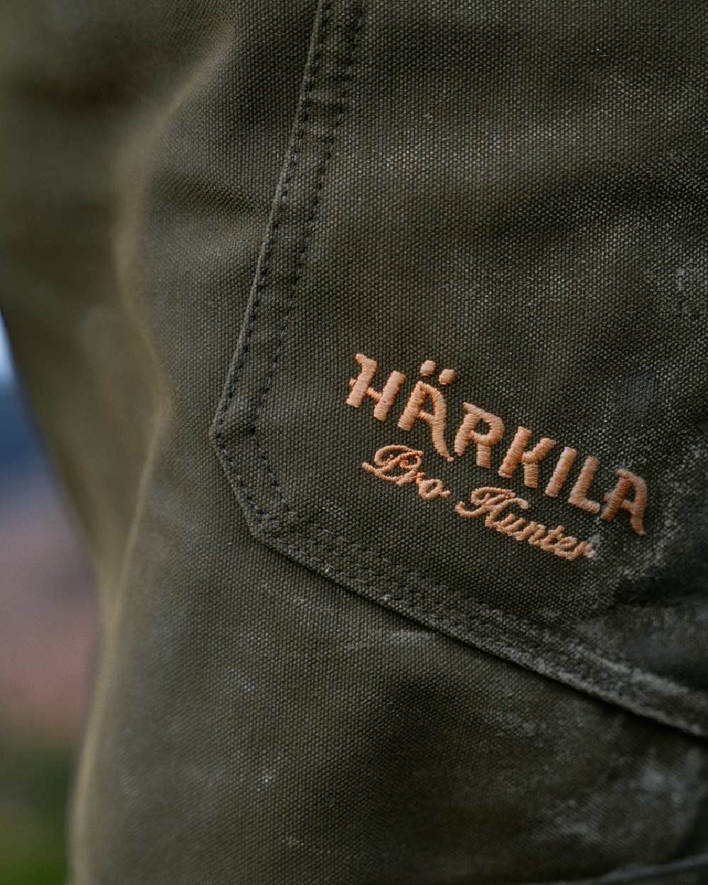 Willow Green Coloured Harkila Pro Hunter Move Trousers on outdoor background