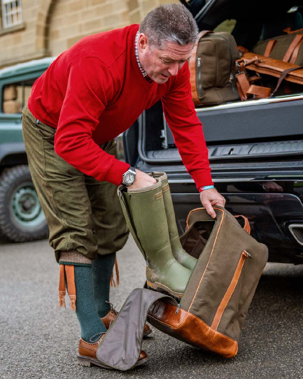 Warm Olive coloured Harkila Retrieve Boot Bag on car background