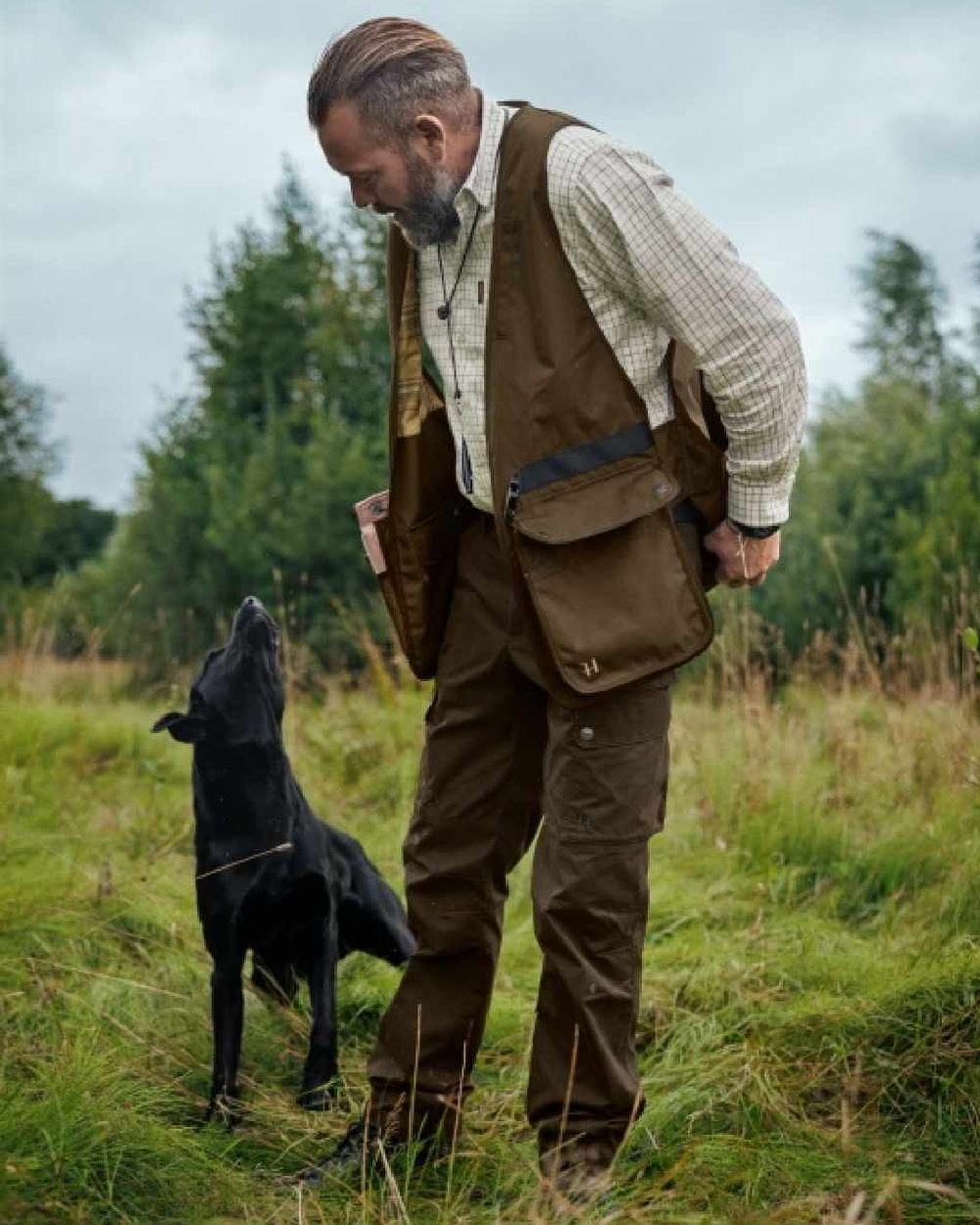 Warm Olive Coloured Harkila Retrieve Dummy Waistcoat on outdoor background