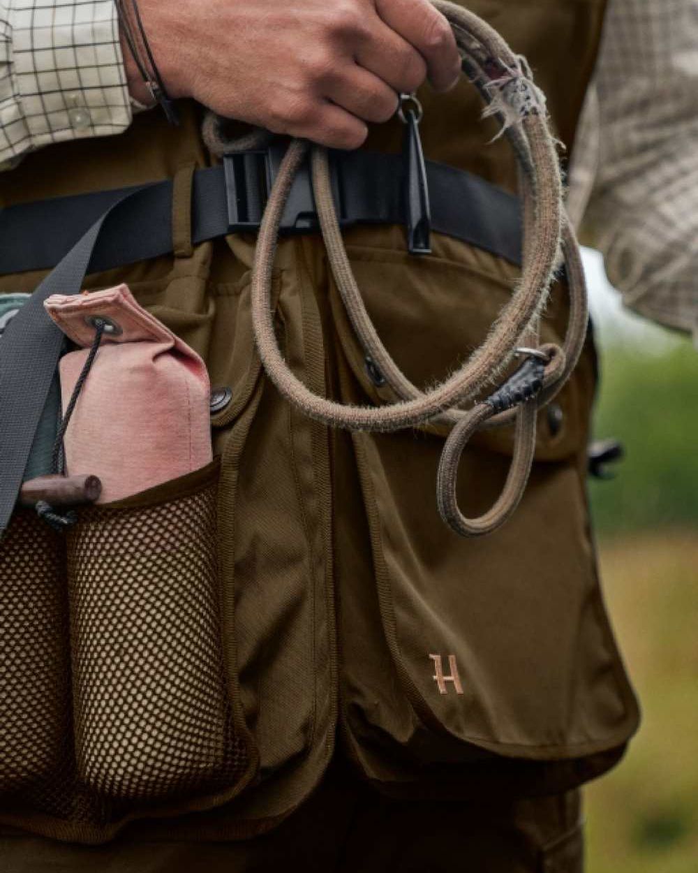 Warm Olive Coloured Harkila Retrieve Dummy Waistcoat on outdoor background