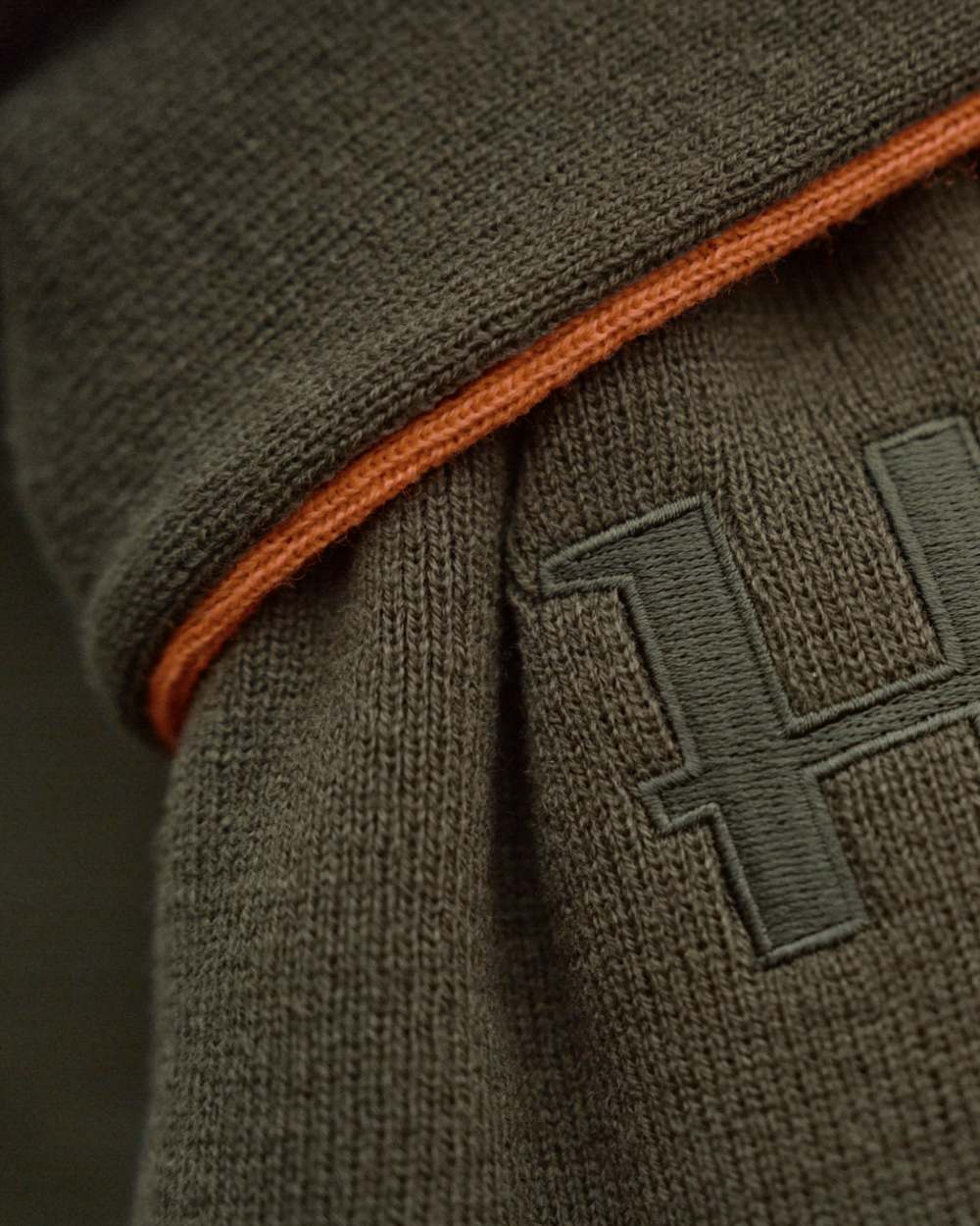 Willow Green Orange Coloured Harkila Reversible Scarf on outdoor background