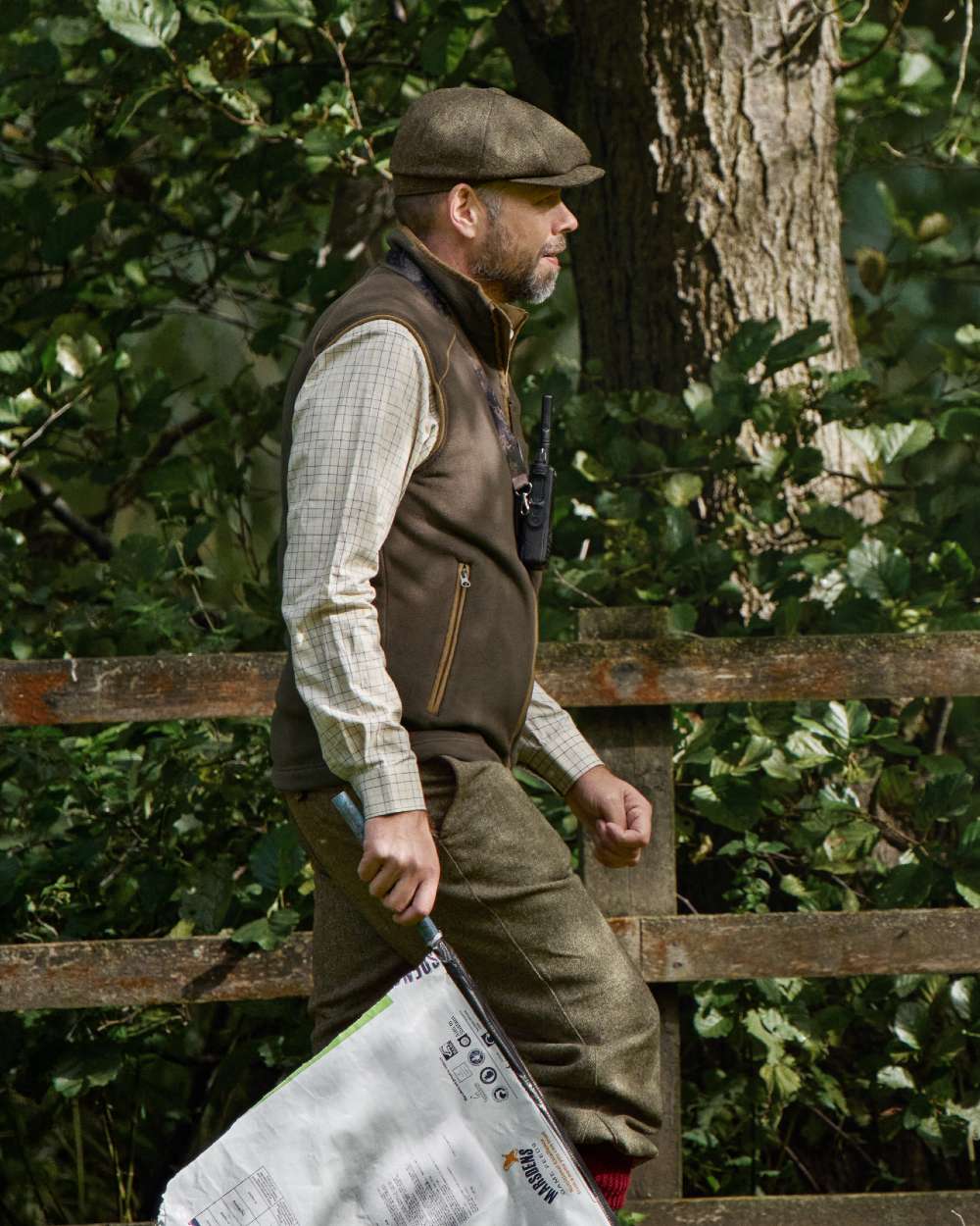 Demitasse Brown Coloured Harkila Sandhem 200 Fleece Waistcoat on forest background