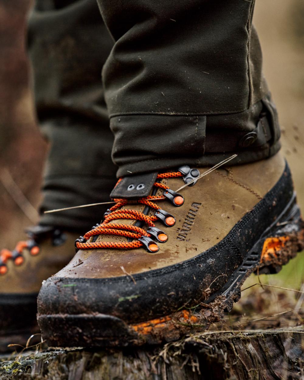 Mid Brown Orange Coloured Harkila Saxnas GTX Boots on mud background