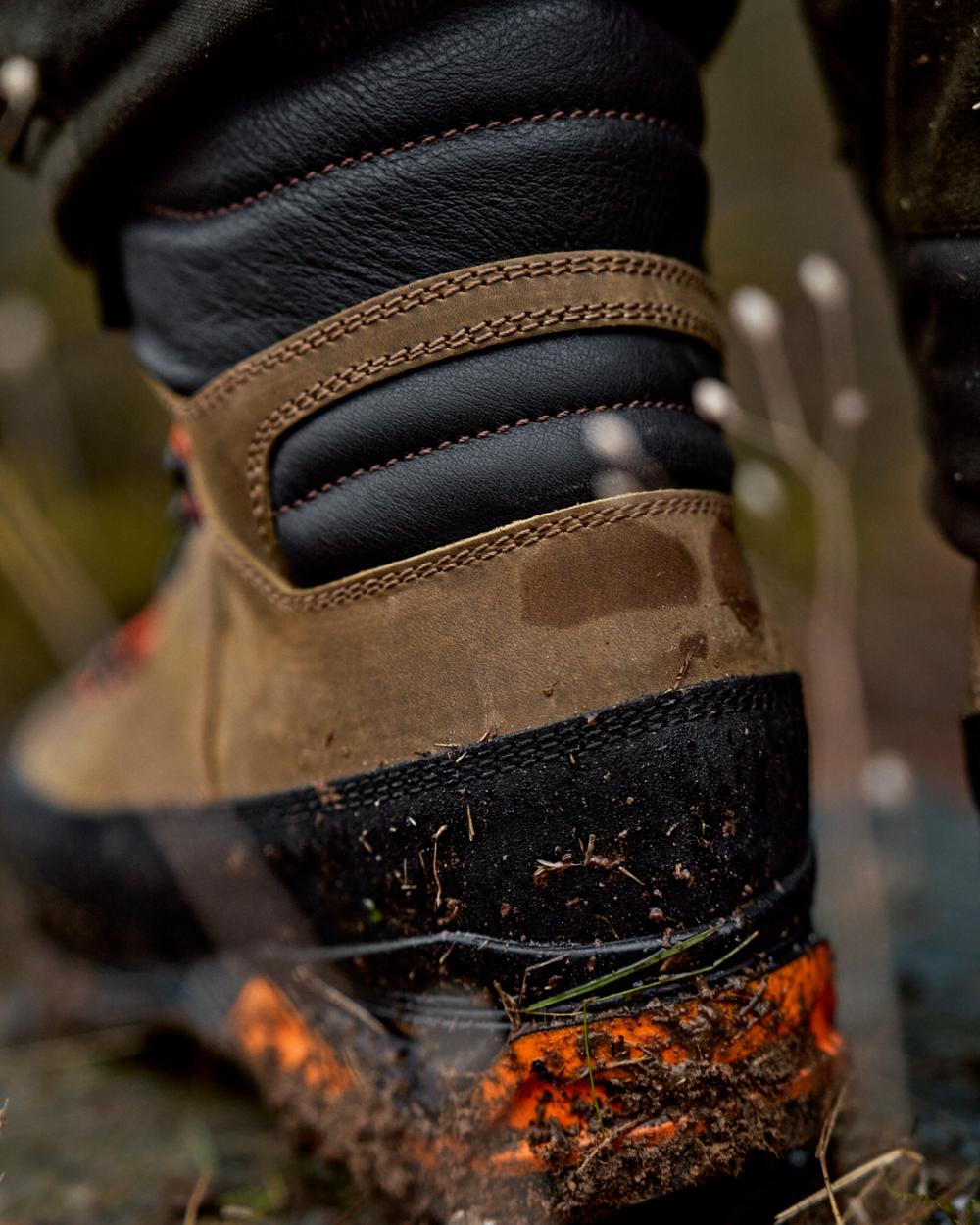Mid Brown Orange Coloured Harkila Saxnas GTX Boots on mud background