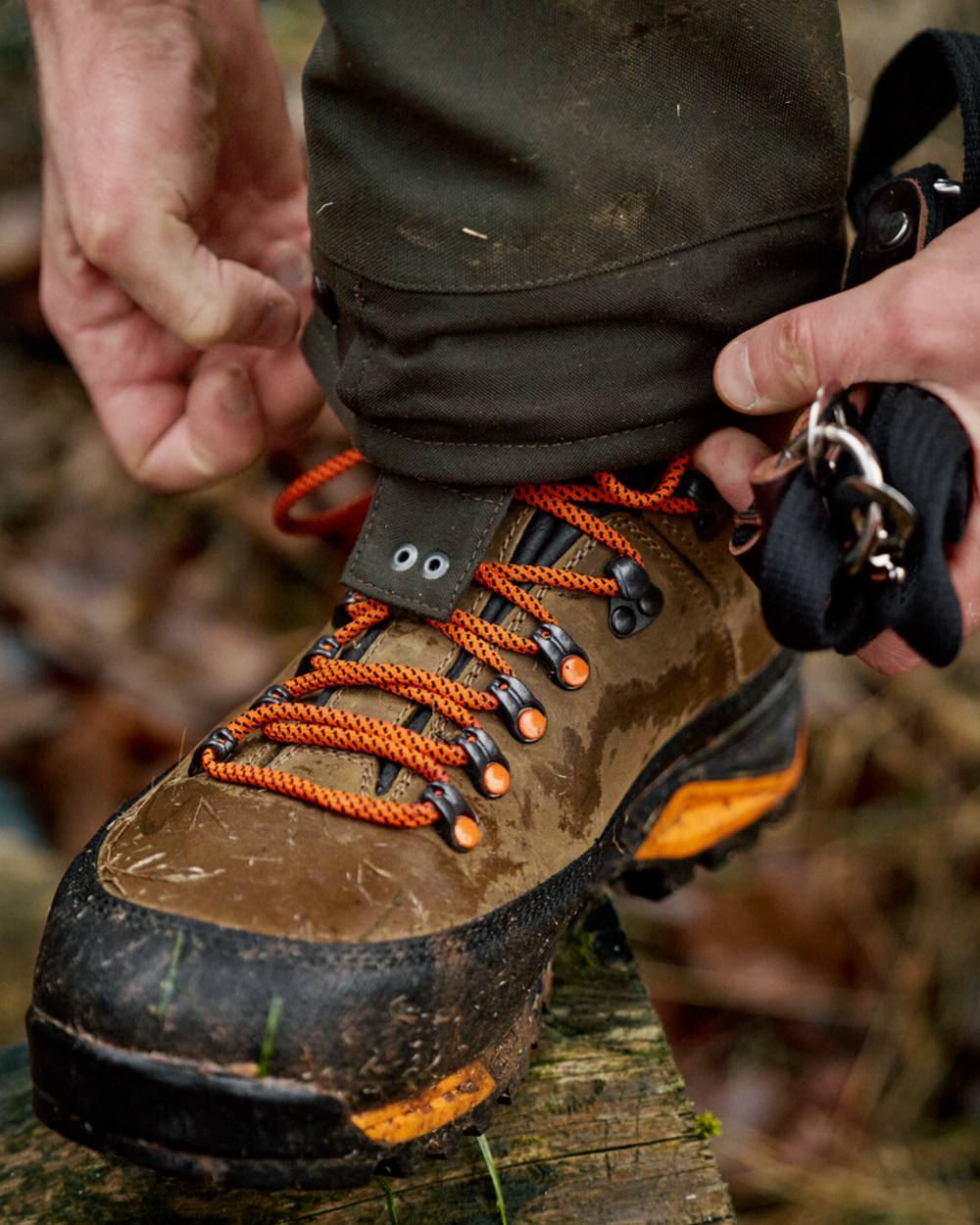 Mid Brown Orange Coloured Harkila Saxnas GTX Boots on mud background
