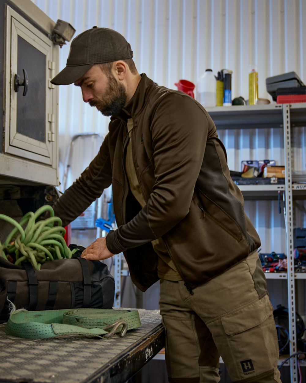 Willow Green Deep Brown Coloured Harkila Scandinavian Fleece Jacket on house background