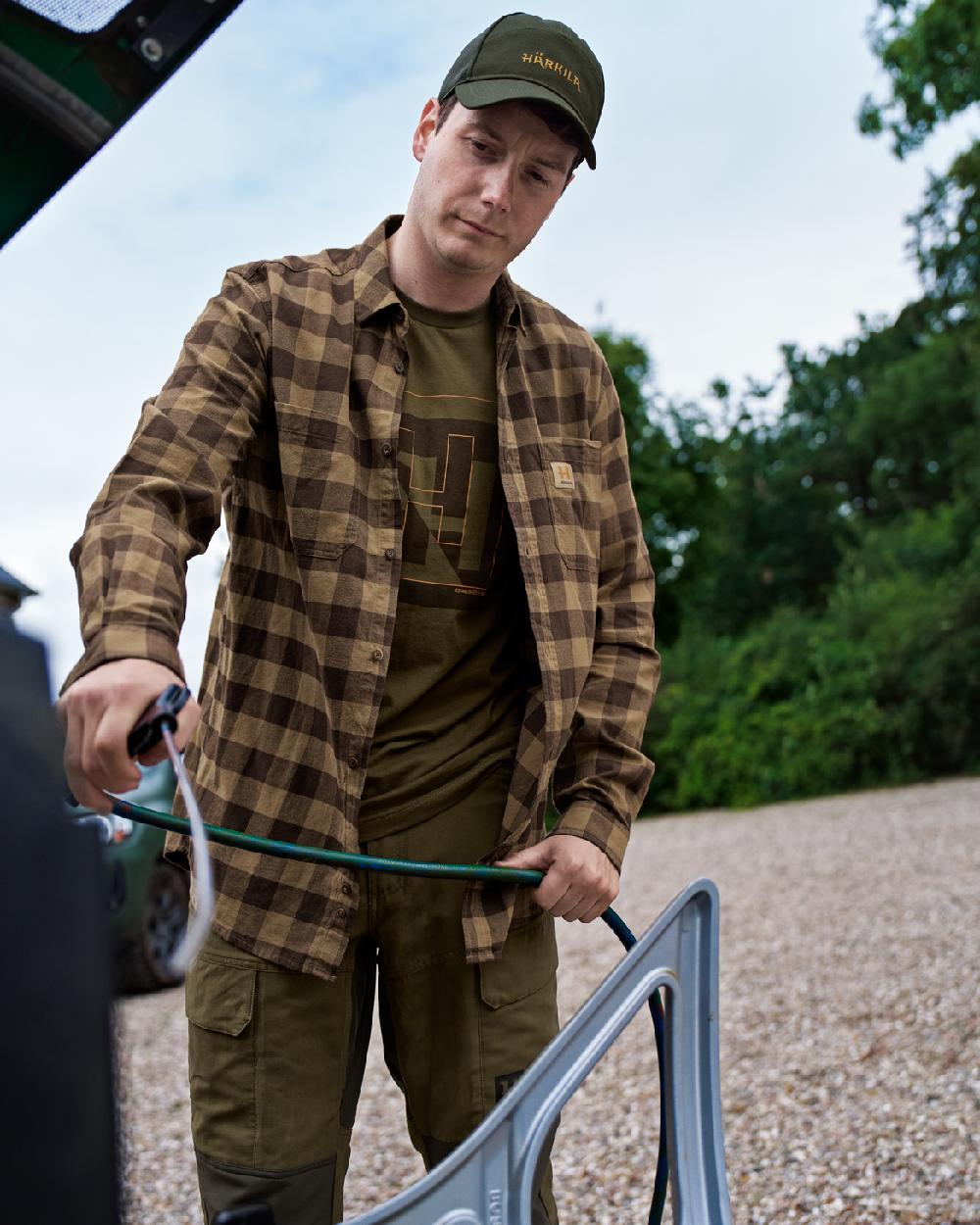 Antique Bronze Check Coloured Harkila Scandinavian Long Sleeve Shirt on countryside background