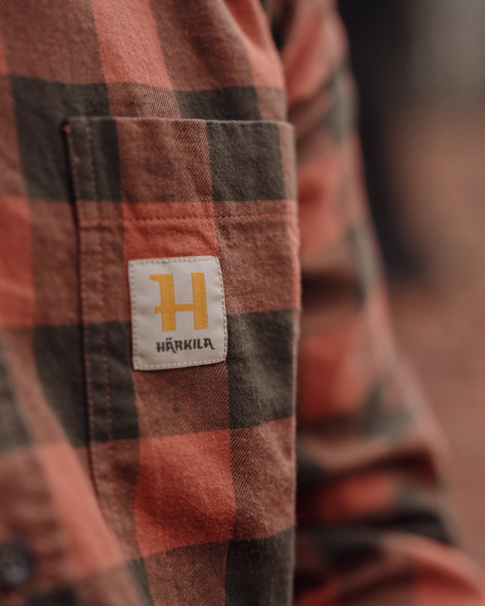 Autumn Orange Check coloured Harkila Scandinavian Long Sleeve Shirt on outdoor background