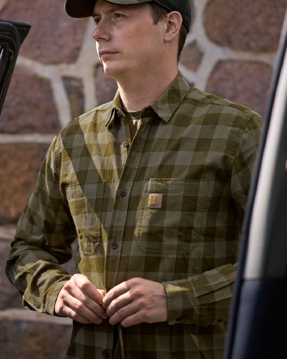 Dark Olive Check Coloured Harkila Scandinavian Long Sleeve Shirt on blurry background