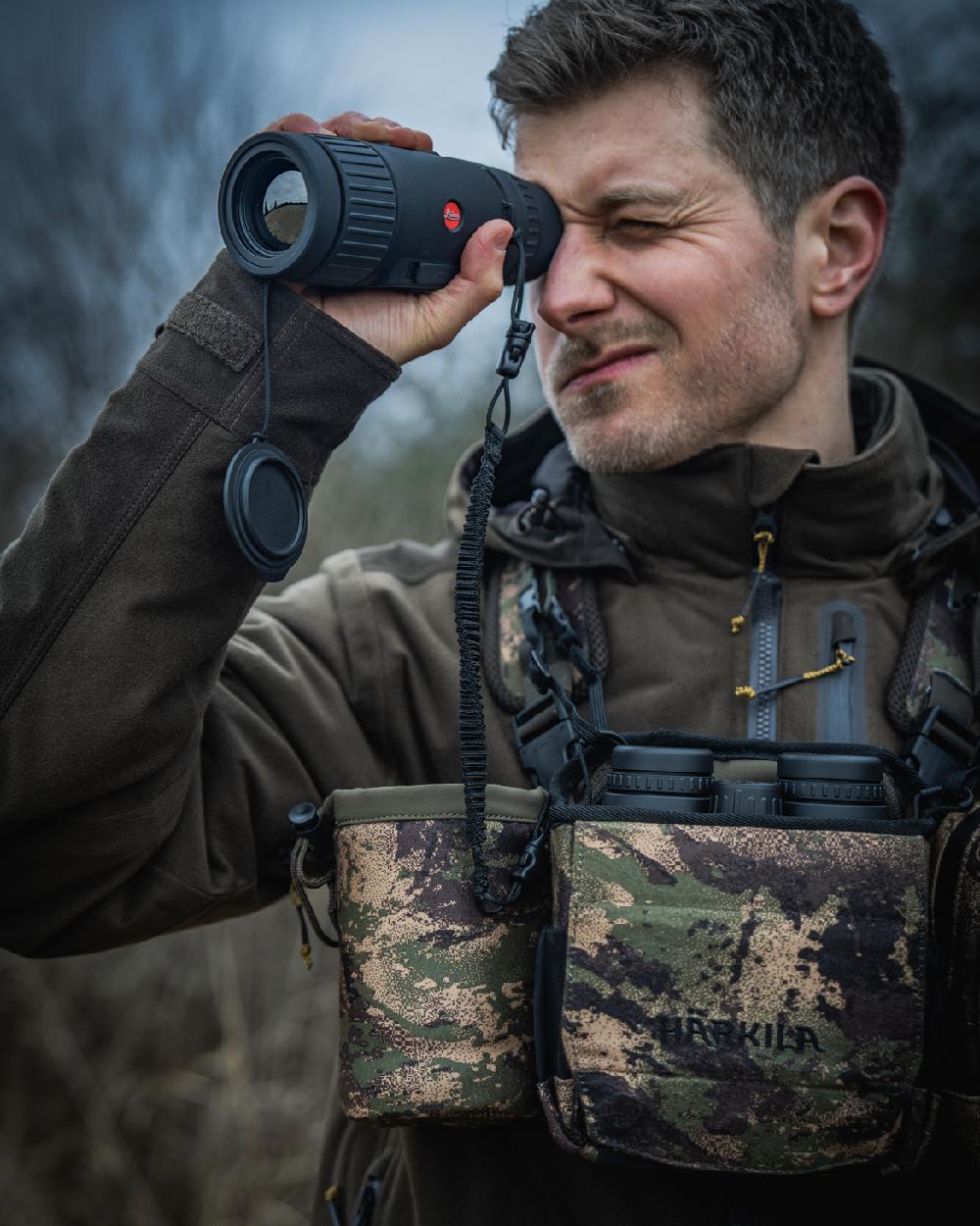 AXIS MSPForest Coloured Harkila Thermal Camo Spotter Pouch on blurry background
