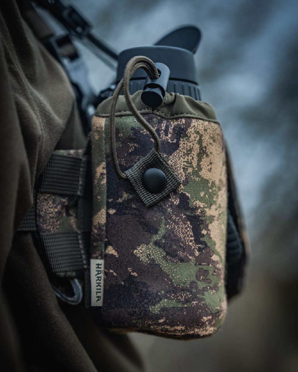 AXIS MSPForest Coloured Harkila Thermal Camo Spotter Pouch on blurry background