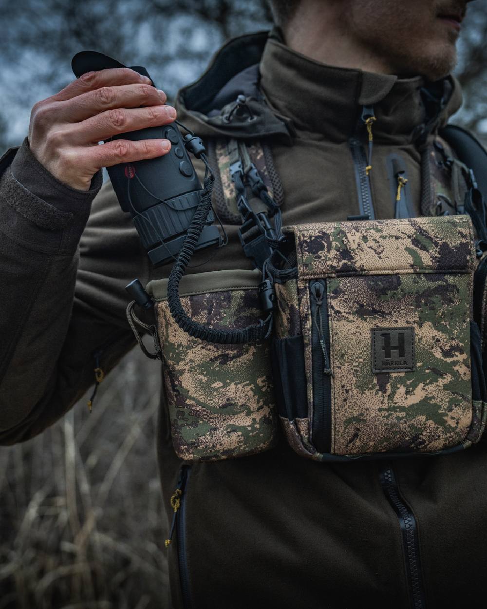AXIS MSPForest Coloured Harkila Thermal Camo Spotter Pouch on blurry background