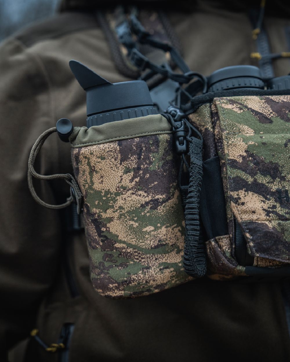 AXIS MSPForest Coloured Harkila Thermal Camo Spotter Pouch on blurry background