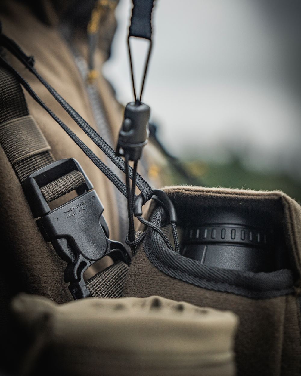 Dark Willow Green Coloured Harkila Thermal Spotter Pouch on blurry background