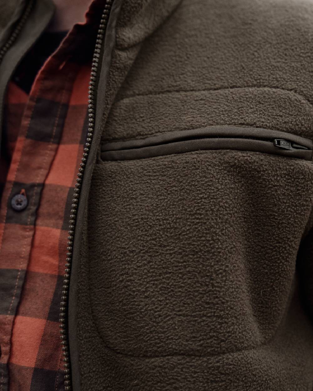 Dark Brown coloured Harkila Torsby Fleece Jacket on outdoor background