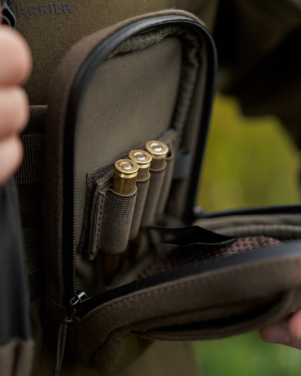 Dark Willow Green Coloured Harkila Utility Pouch on blurry background