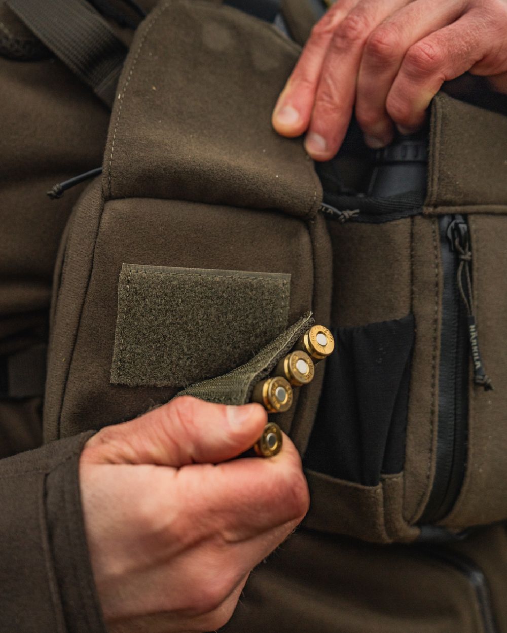 Dark Willow Green Coloured Harkila Utility Pouch on blurry background